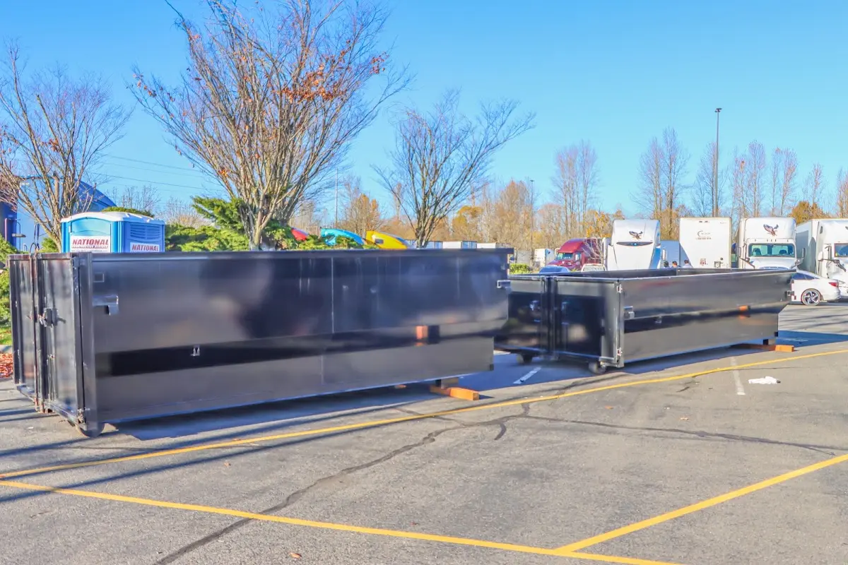 Professional dumpster rental service with roll-off container on residential driveway in Placerville